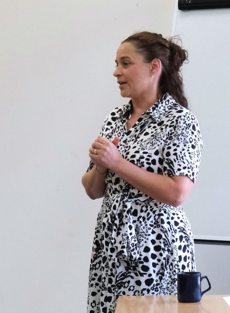 Anne presenting at the front of a group